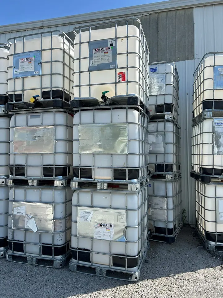 IBC totes stacked two high in a yard
