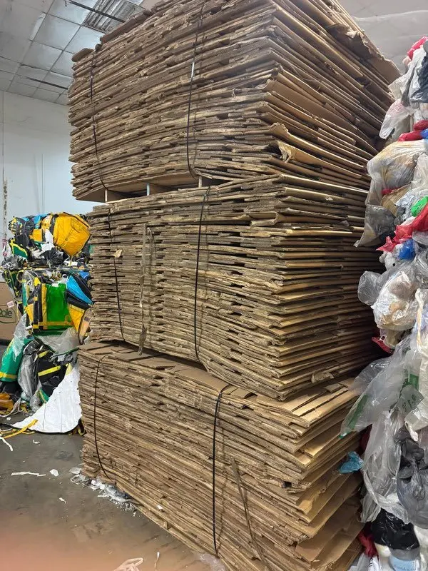 Tall stacks of flattened used corrugated boxes